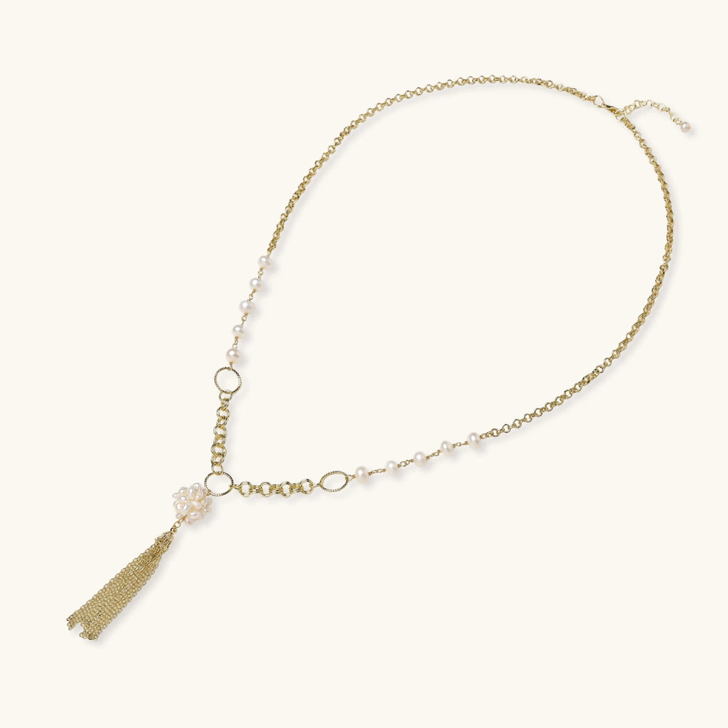 Long gold-plated necklace with freshwater pearls, chunky chain links, and flowing tassel pendant