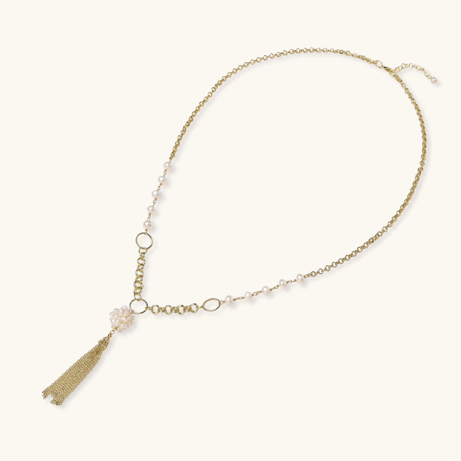 Long gold-plated necklace with freshwater pearls, chunky chain links, and flowing tassel pendant