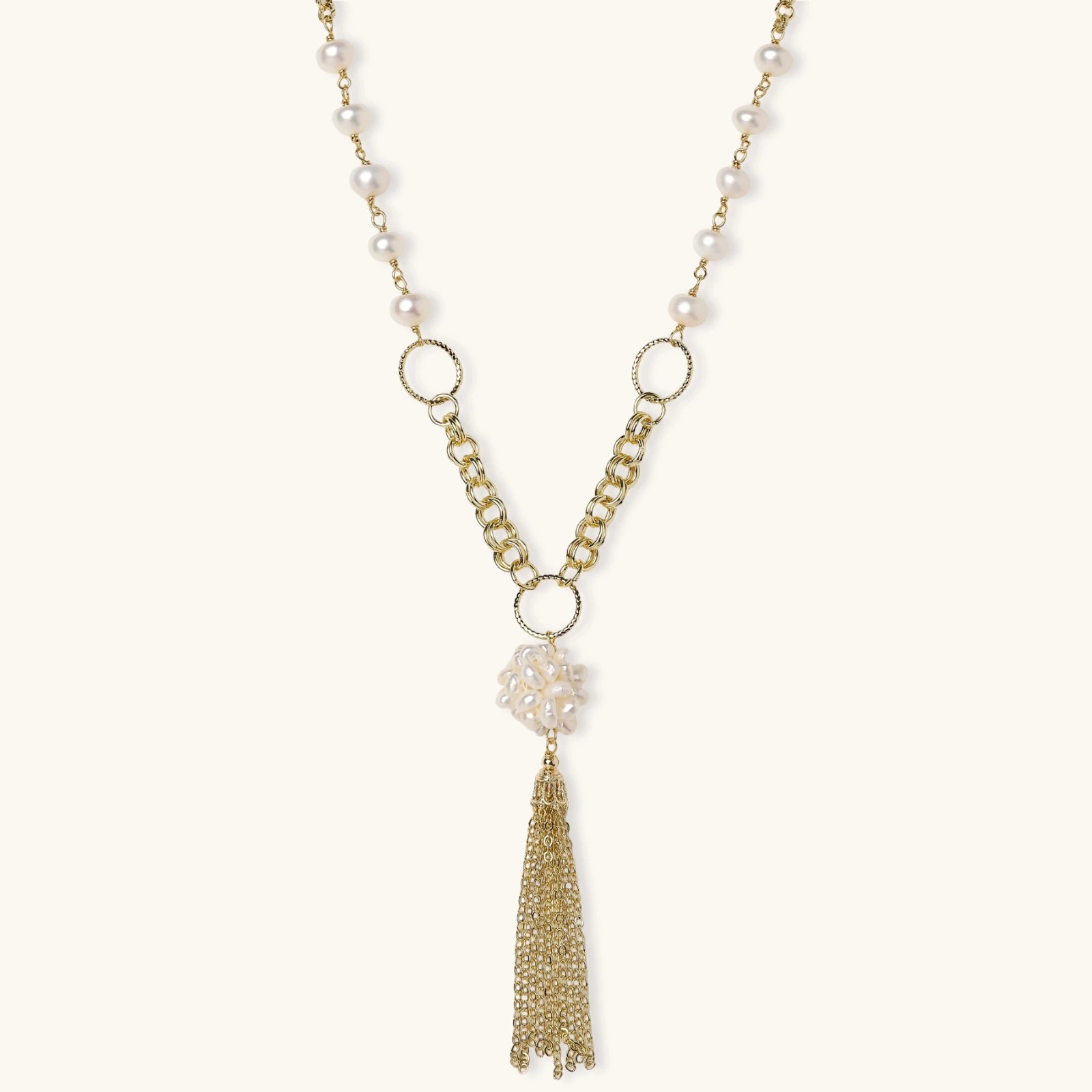 Long gold-plated necklace with freshwater pearls, chunky chain links, and flowing tassel pendant