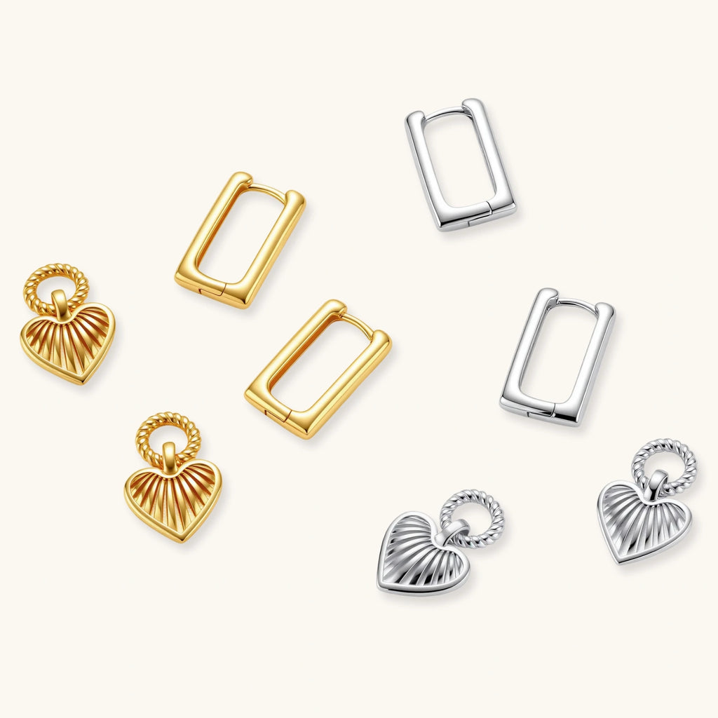 Gold-plated huggie earrings with textured heart charms featuring radiating sunburst patterns on white background.