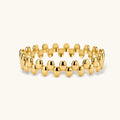 18K gold plated stainless steel bangle with dual rows of polished oval pebble beads on a cream background.