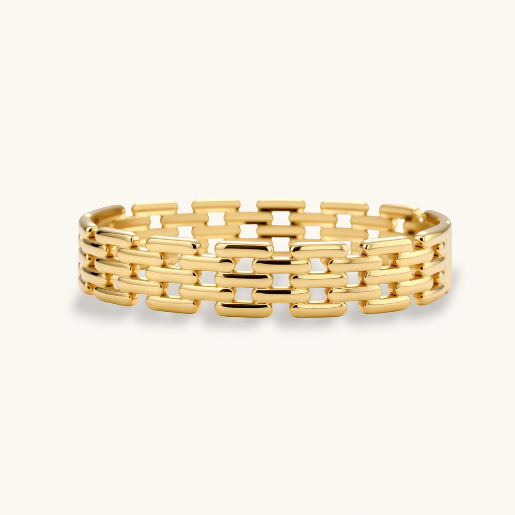 Wide 18K gold plated stainless steel bracelet with a multi-row rectangular grid link chain pattern on a cream background.
