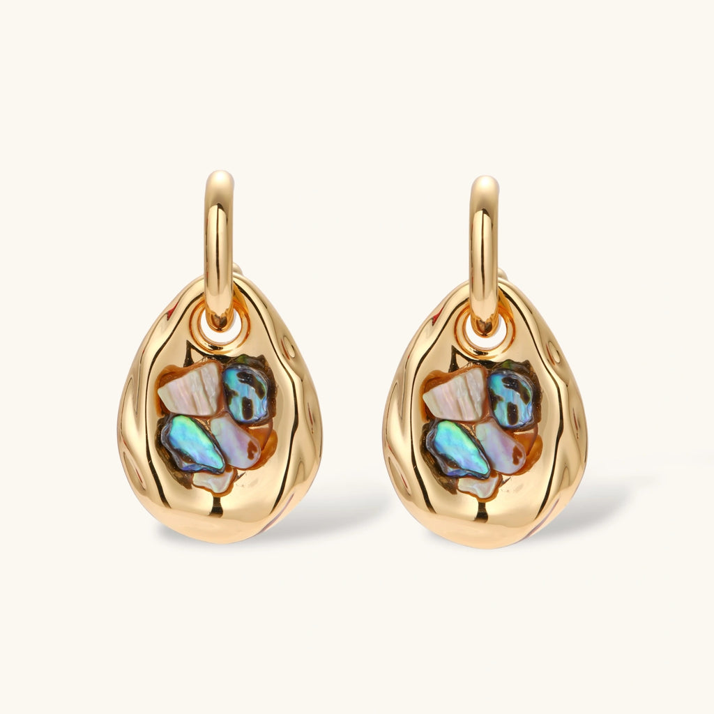 Gold-plated convertible hoop earrings with iridescent shell mosaic pendants, shown assembled and separated on cream background.